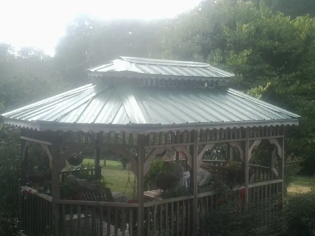 Two tier green metal roof on a garden gazebo in Russell