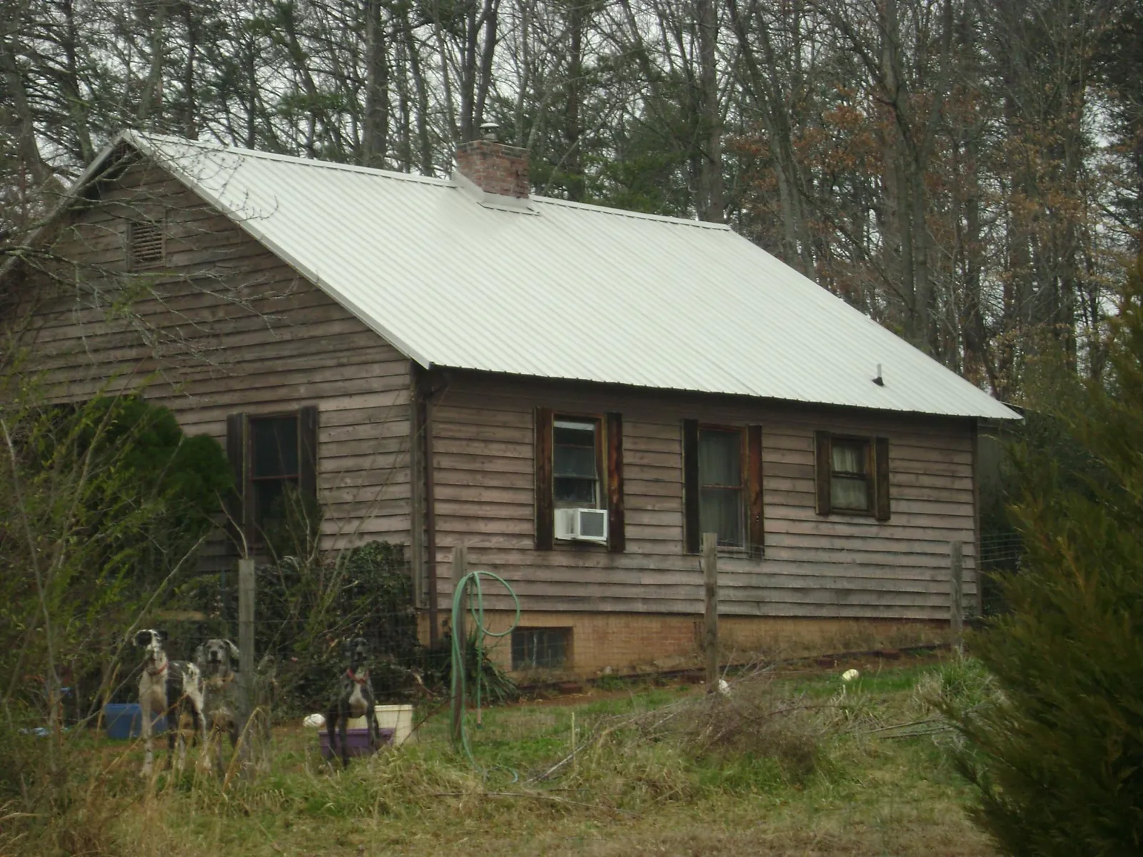 White metal roof on an old wood sided farmhouse, from a Asphalt Shingle Roof Repair job in Russell